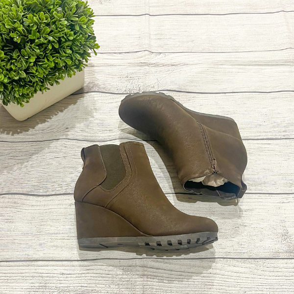 chocolate wedge booties with a flat lay 